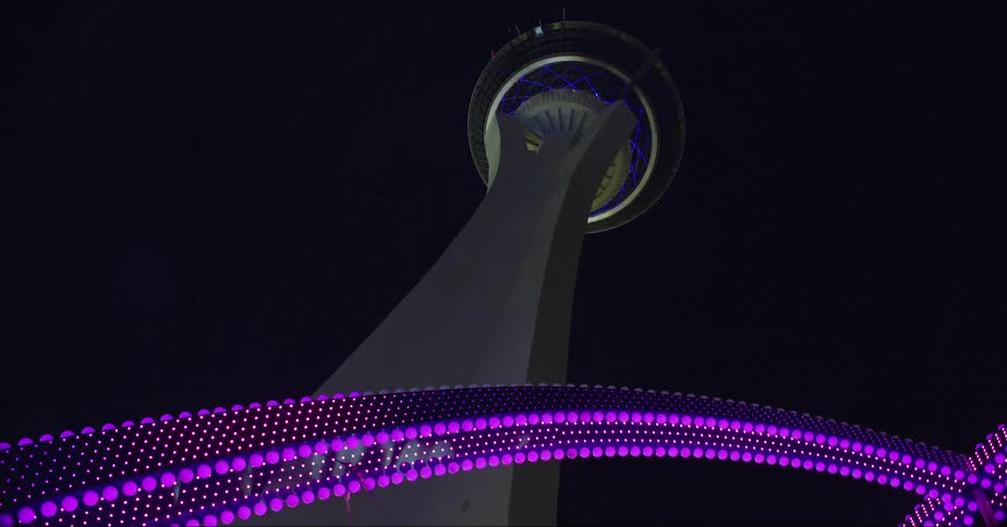 The stratosphere tower in las vegas seen from a moving vehicle at evening