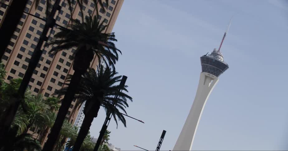 A tower looms over a roadway in a metropolis during the day