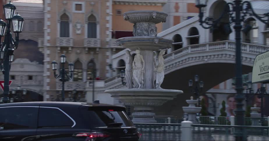 Cars driving by the venetian on the las vegas strip