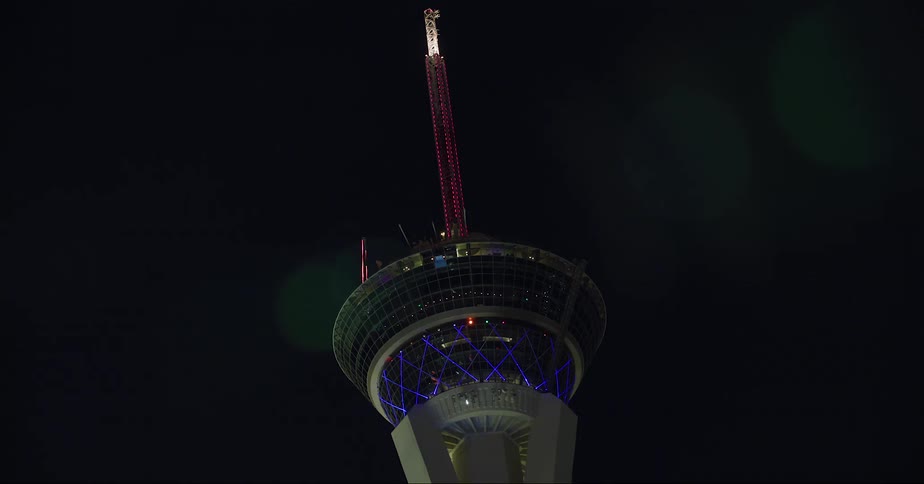 The stratosphere tower in las vegas seen from a moving vehicle at night