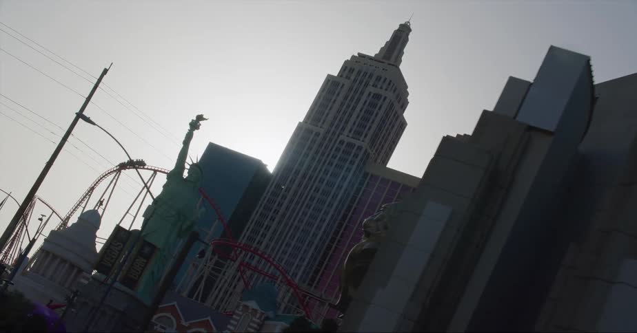 Vehicle drives on highway next to skyscrapers and high rise buildings in the city