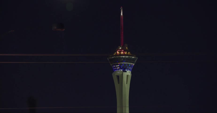 The stratosphere tower in las vegas seen from a moving vehicle at night