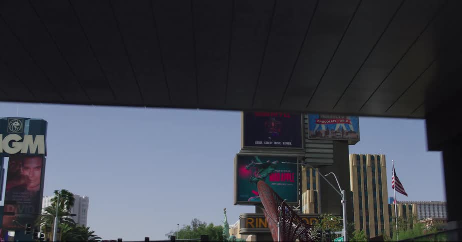 Traffic crosses under pedestrian bridge while passing casinos on the las vegas strip