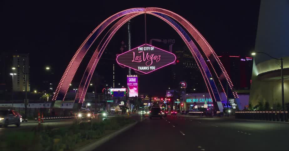 Las vegas boulevard gateway arches and showgirls at night