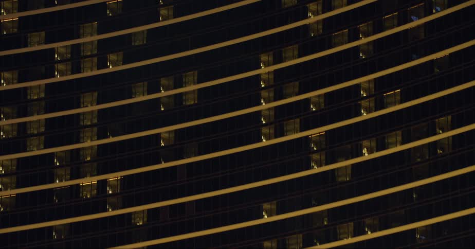 The facade of a large building in a metropolis at night