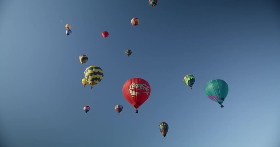 Many hot air balloons float in the sky