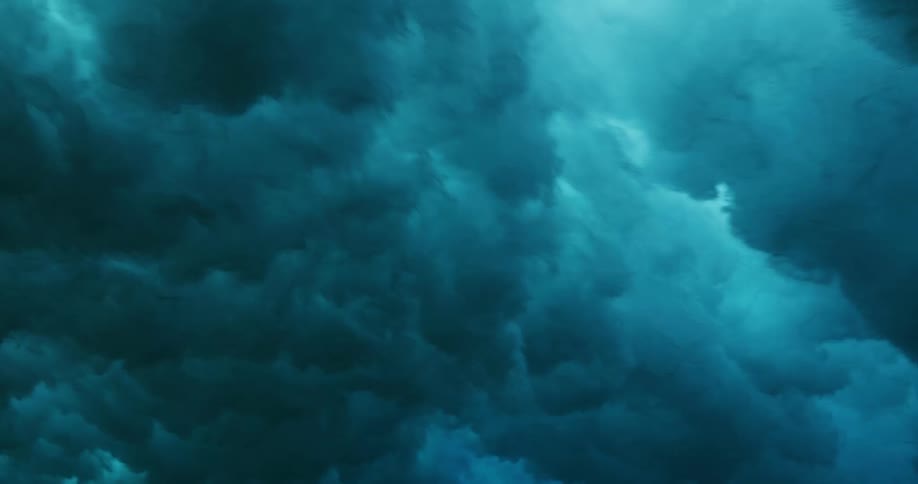 Underwater footage of waves rolling oververhead on the blue ocean waters