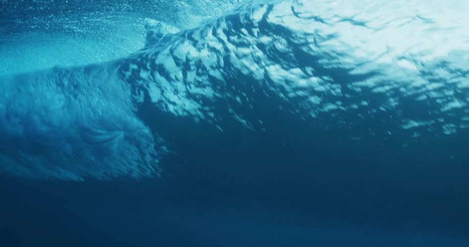 Underwater shot of a wave forming in a body of water