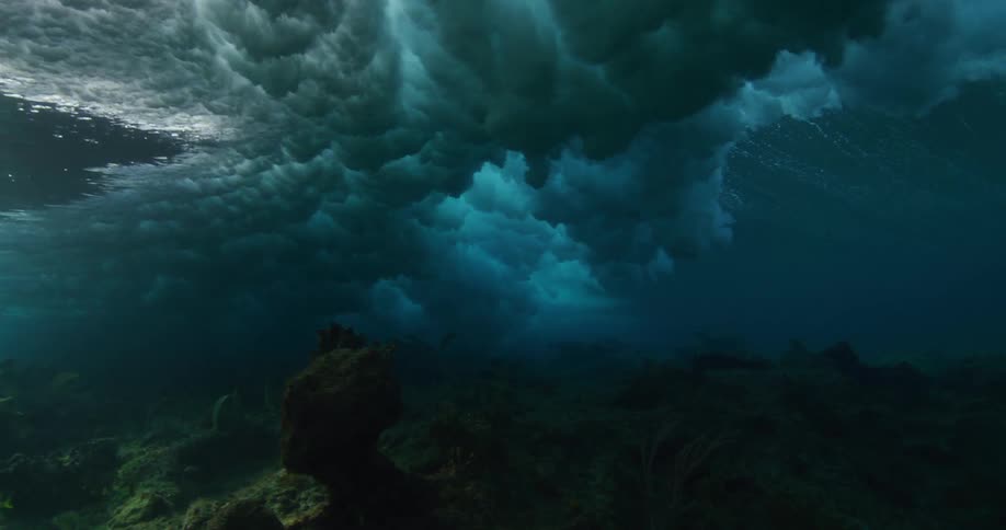 Underwater footage of waves rolling over coral reefs in the tropics