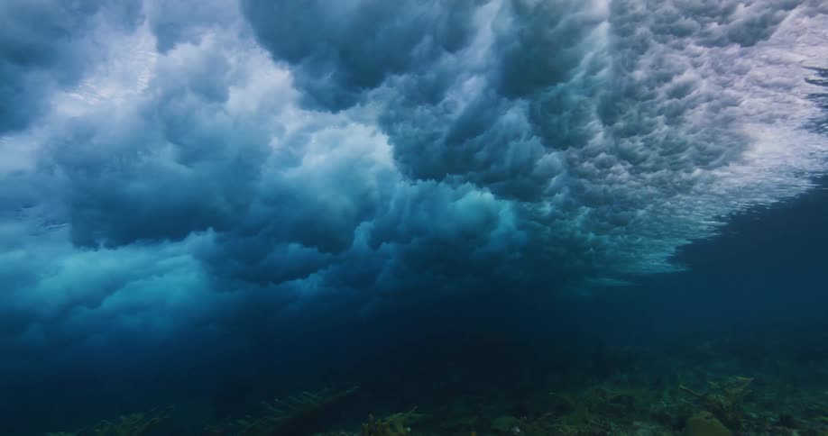 Underwater footage of waves rolling over coral reefs in the tropics