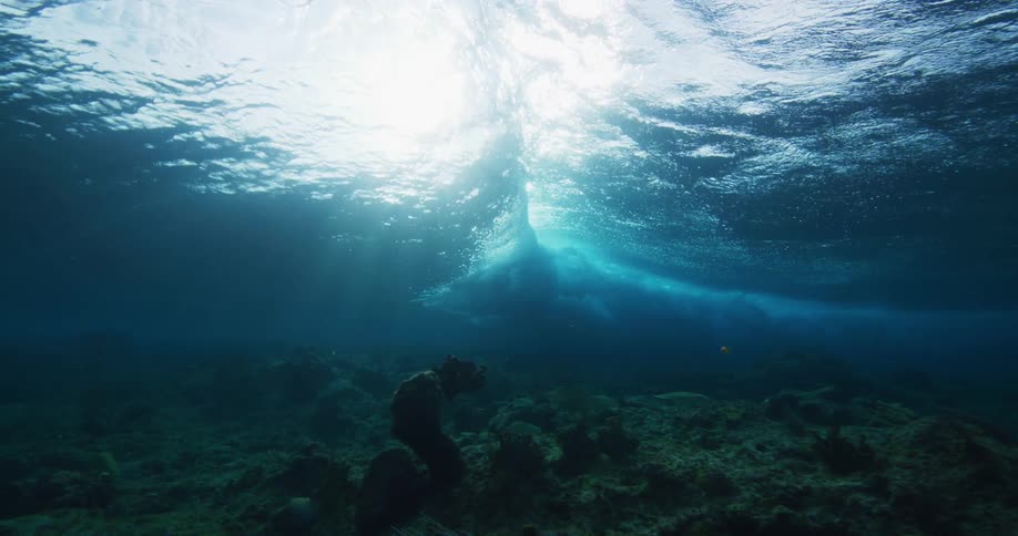 Underwater footage of waves rolling over coral reefs in the tropics