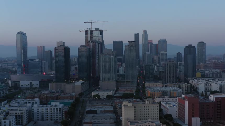 Aerial view of high rise office buildings and highways in the city at dusk