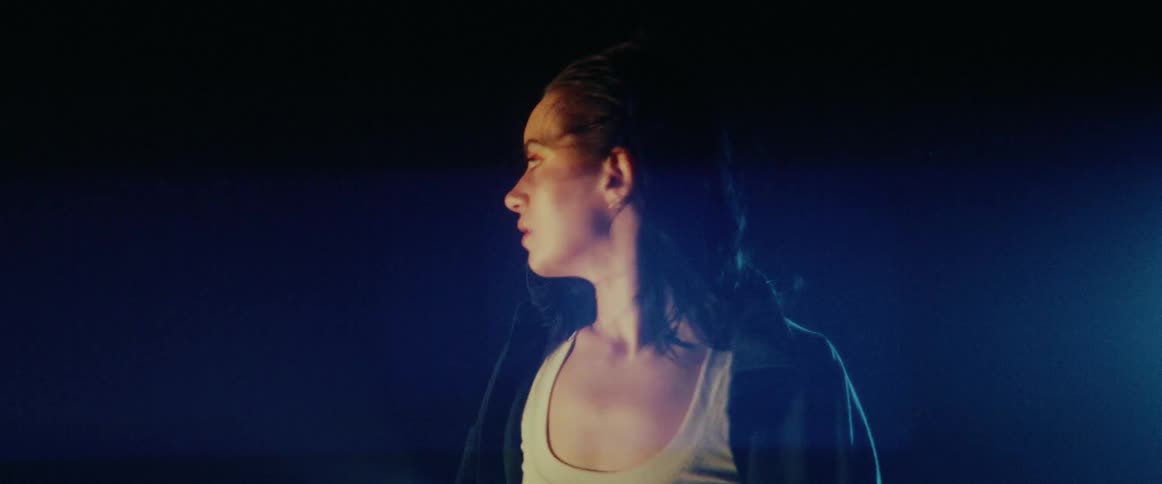 A woman standing outdoors in a strobe light