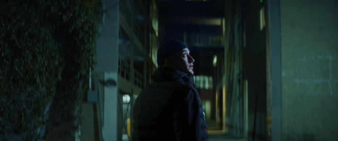 A man walks down the dark alley