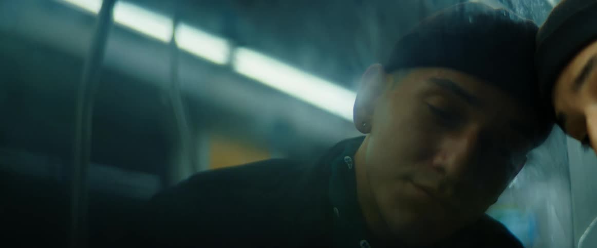 A man is looking out the window during transportation