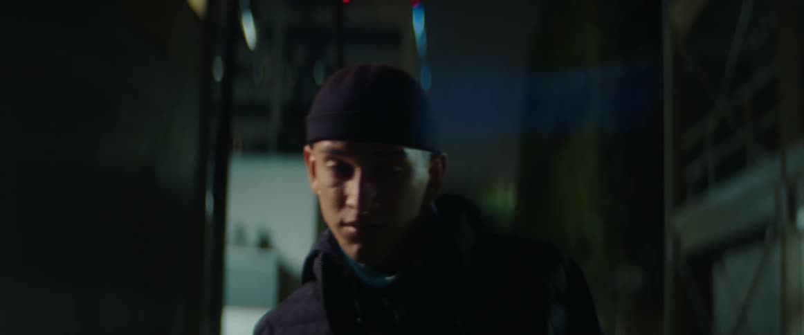 Man walks along dark alley at night searching