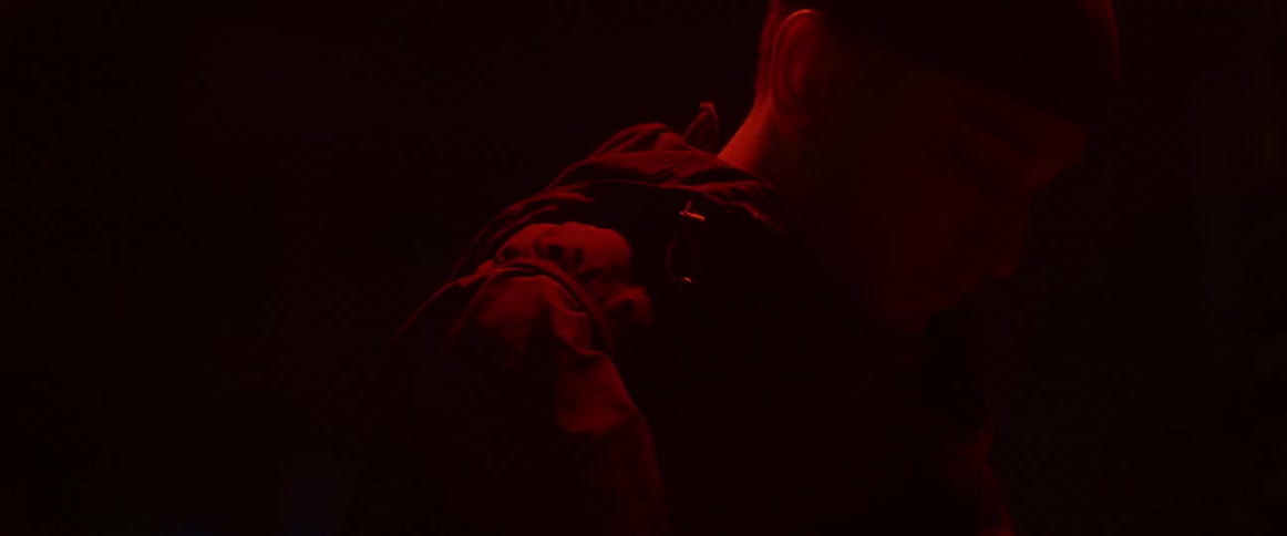 A man is standing outdoors during the night time