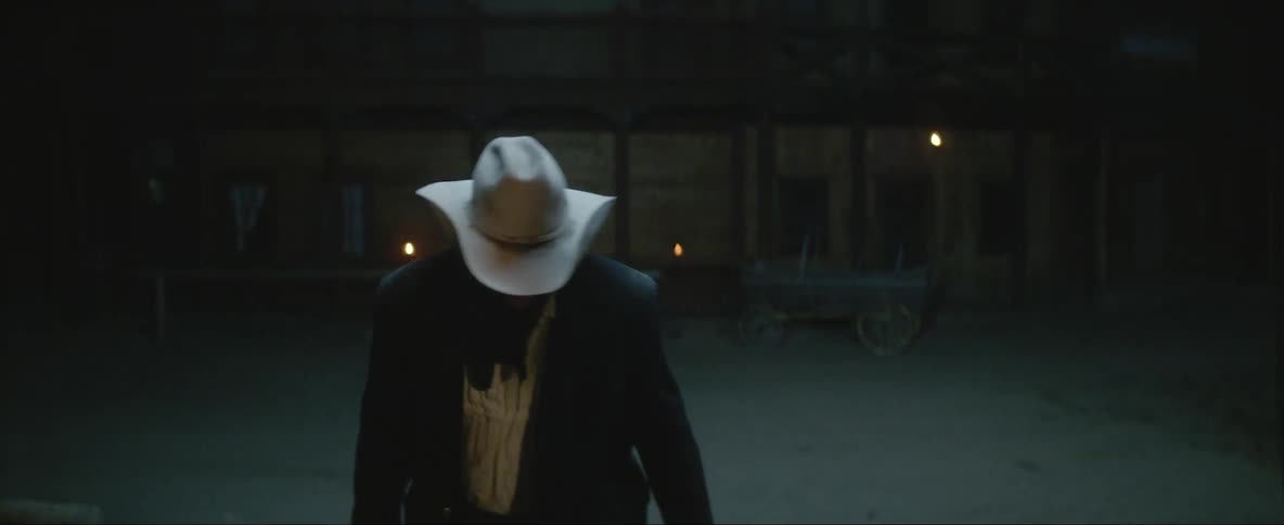 A man walks into a crowded saloon