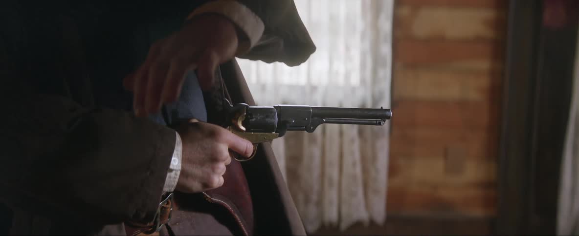 A man pulls and aims his gun