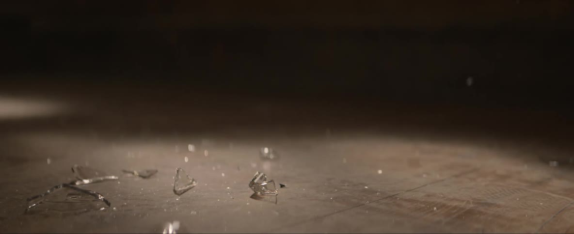Glass is dropped from above and shatters on the floor