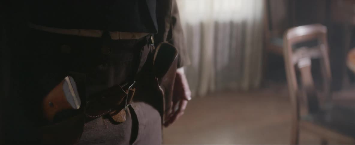 Hands and fingers twitch as the person draws a gun from their waist holster