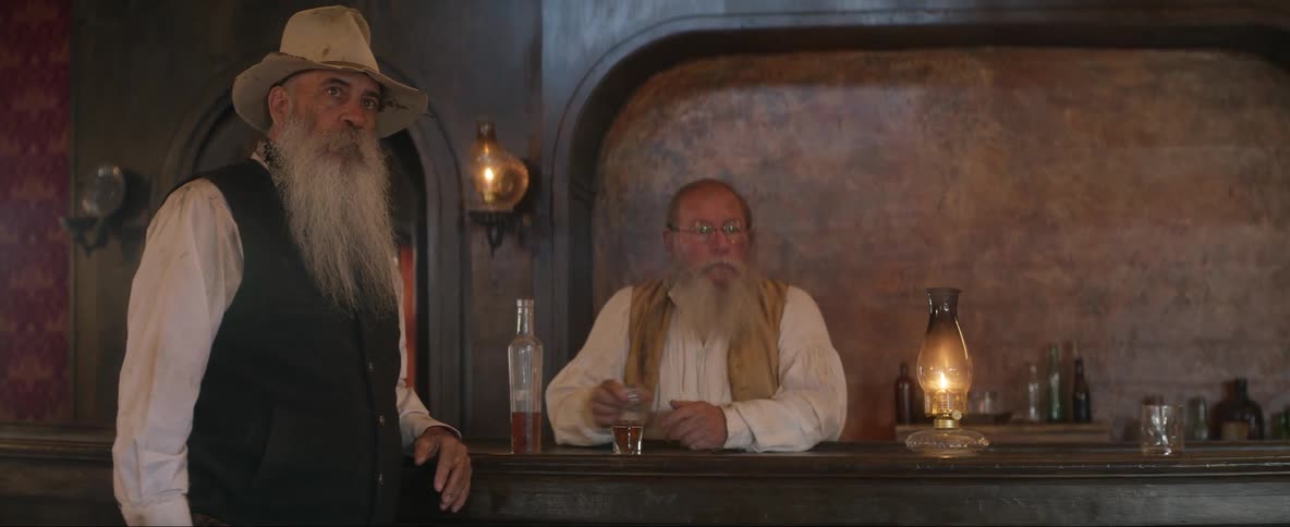 Cowboy talking to the bartender suddenly unholsters his revolver and gets shot