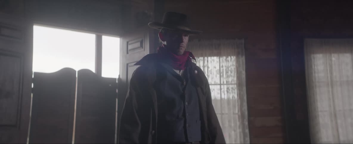 A cowboy walks into a saloon waving a gun around