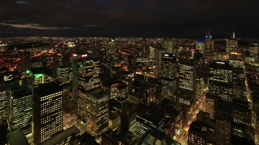 A city changes into night as all the buildings light up