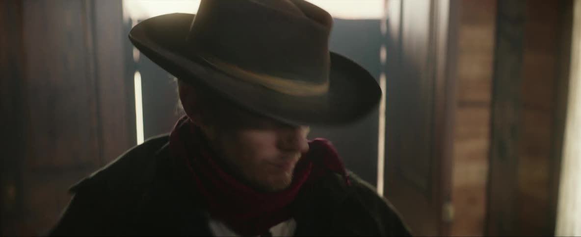 The cowboy points around the room