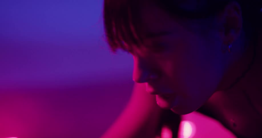 A woman breathing heavily while working out on a stationary bike