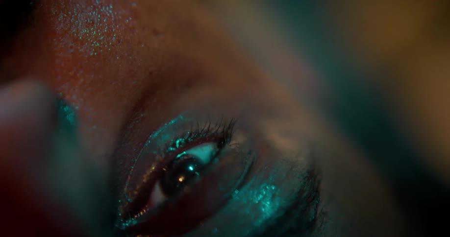 A woman closes her eyes tightly while looking up