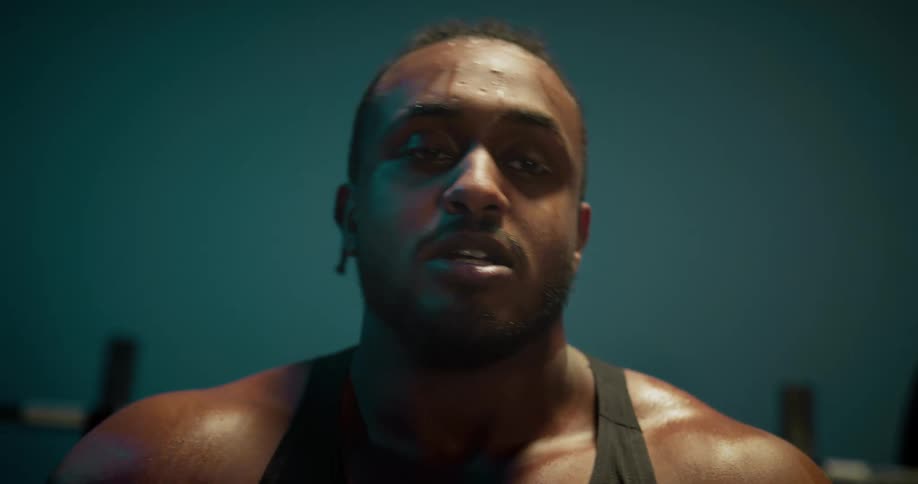 Close up of the face of a strong muscular man standing up after lifting weights