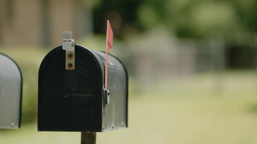 A black mailbox in a residential area