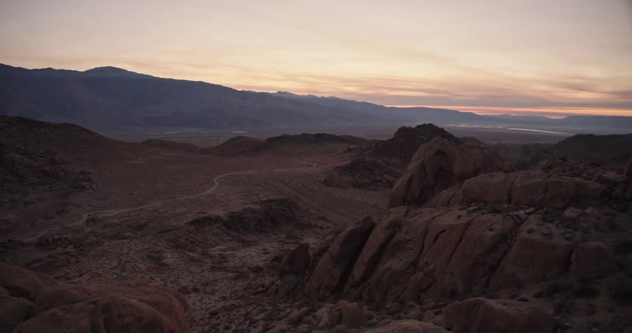 The sun is setting in the horizon of the mountains
