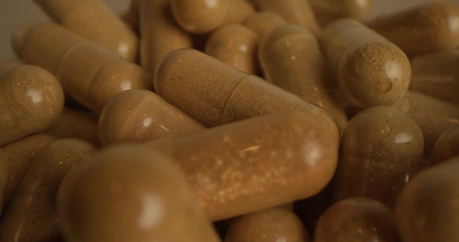 Extreme close up of a pile of brown translucent capsules