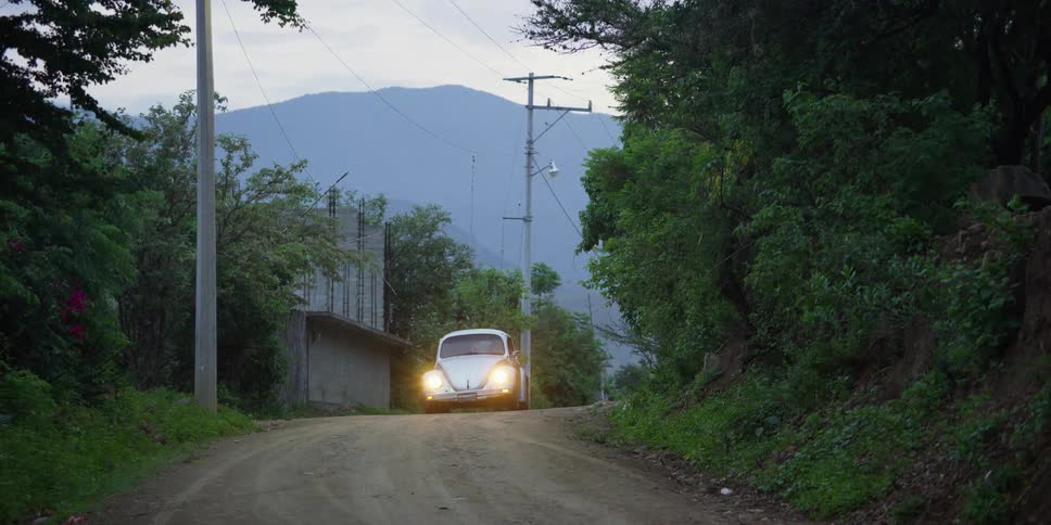Volkswagen driving up a road and parking near the hillside