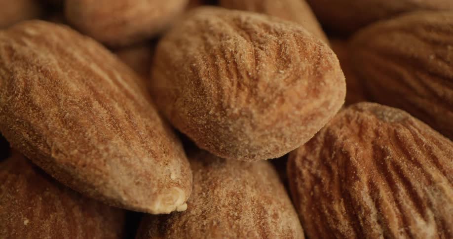 Fine dusting coats pile of almond nuts