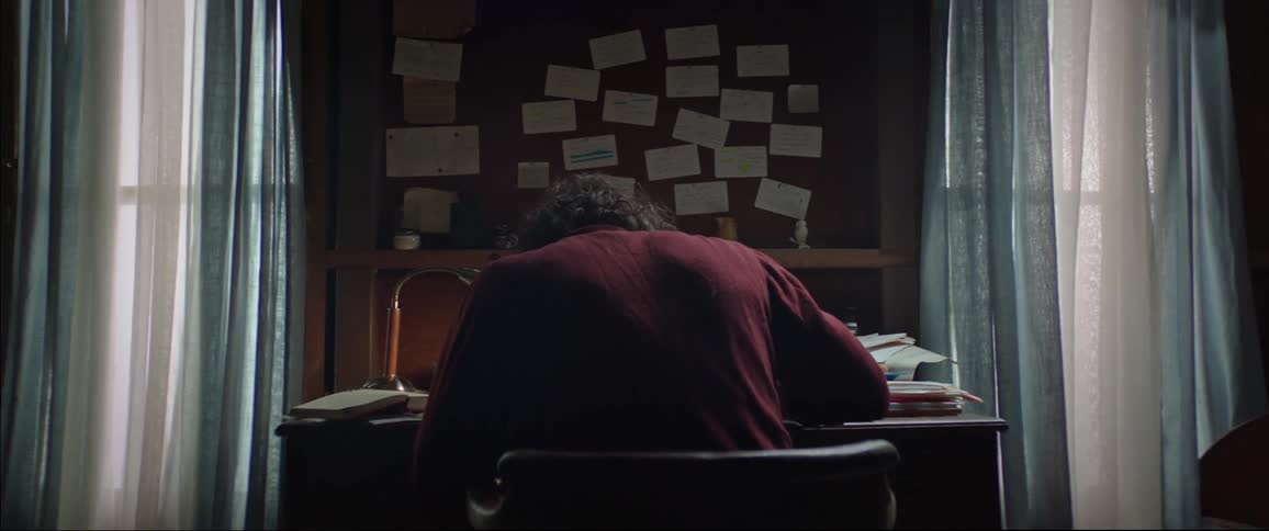 Person sitting at a desk writing
