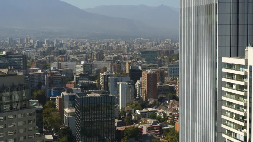 Aerial view of the buildings on a city next to the mountains at daytime