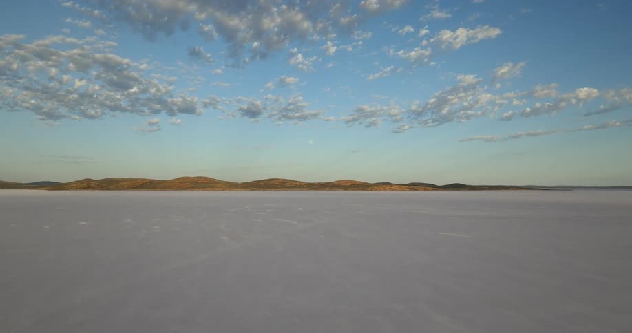 Aerial panoramic view of the flat plains in the desert next to the mountains
