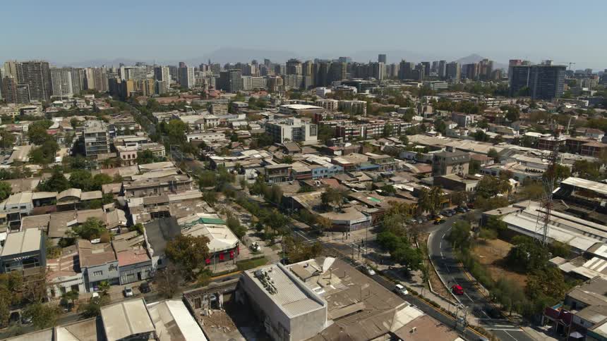 Santiago neighborhood from the air with mountains and city behind
