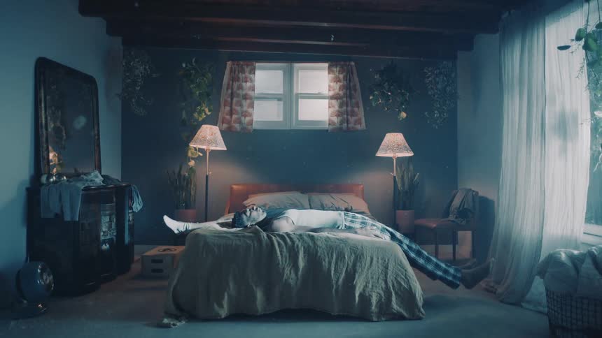 Young couple standing opposite to each other on the bedroom fall over the bed together