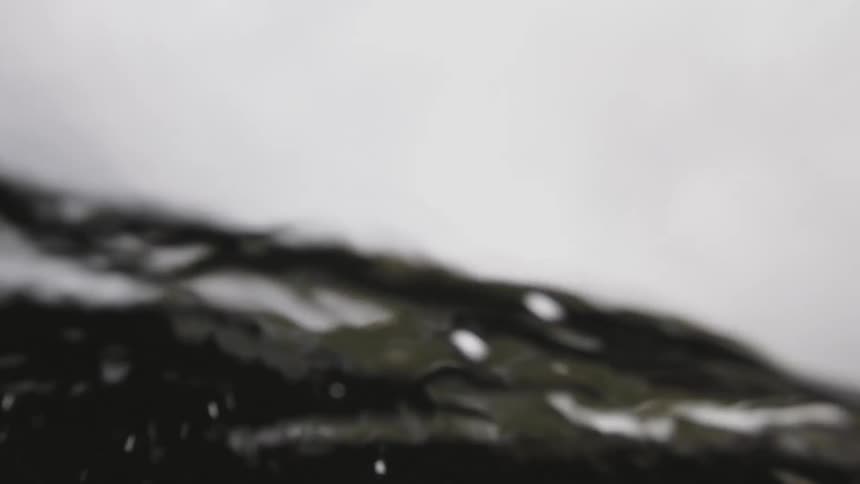 A view underwater of rough waves caused by the wind near the coast on a cloudy day