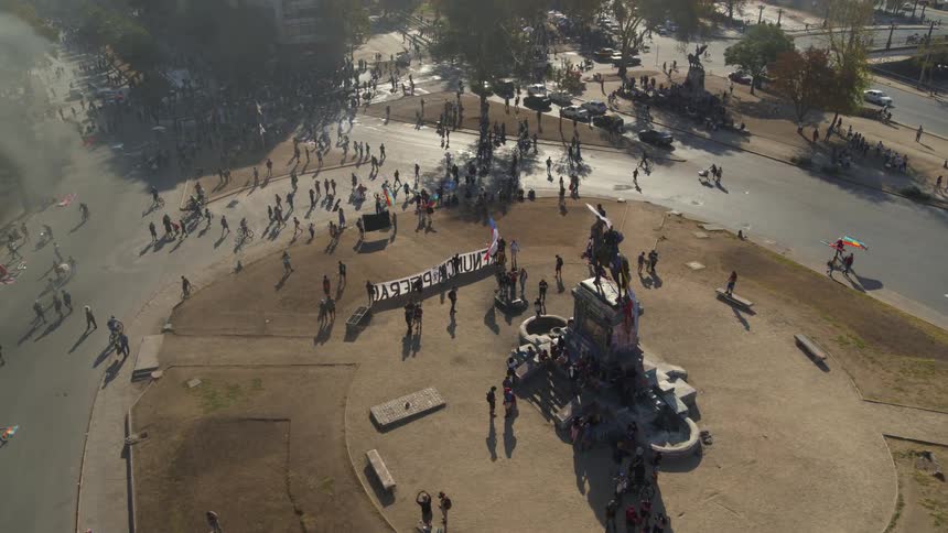 Protesters gather and wave flags in Santiago