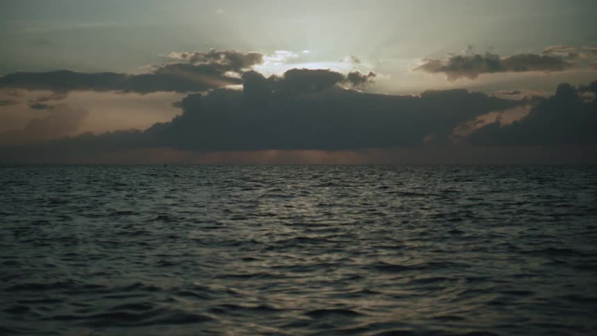 The sun is rising on the ocean