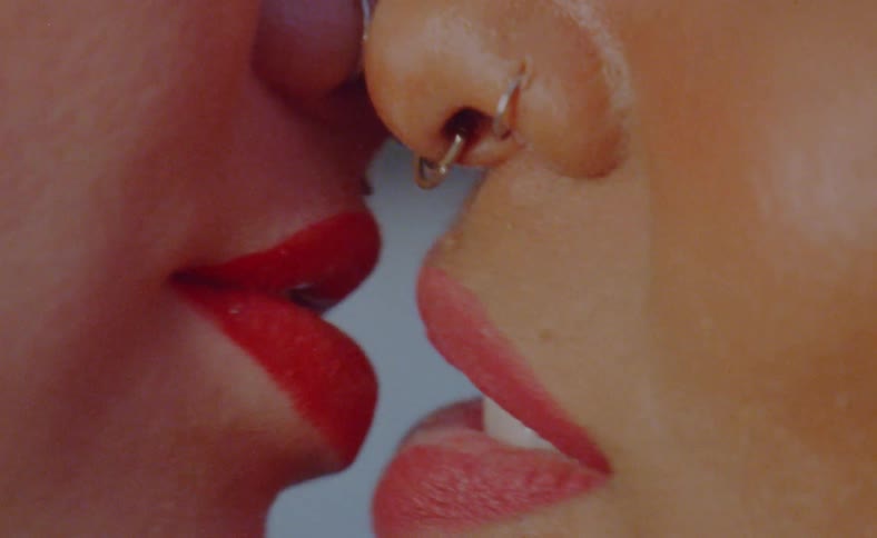 Lesbian women with piercings make out and smile