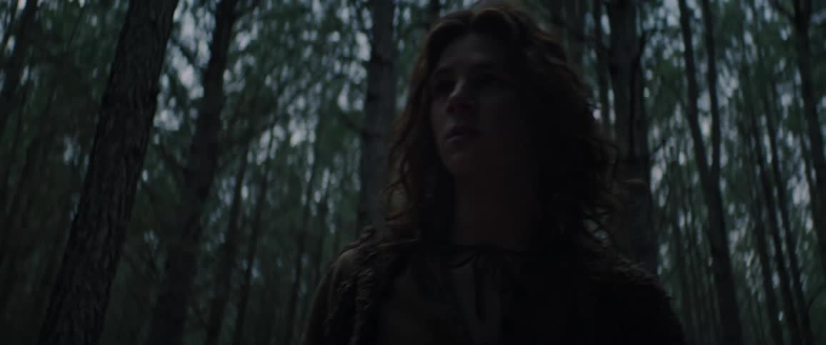 A young man afraid and lost in the woods