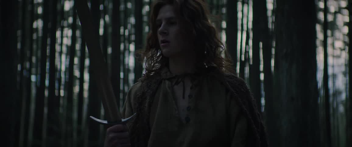Young man looks at magical sword