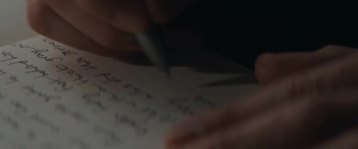 Close up of a persons hand as they write on paper