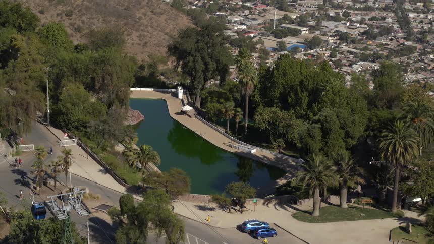Traffic passes by a pool near a large neighborhood